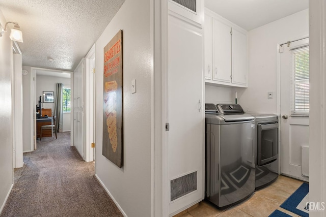 2924 Elm St, Bakersfield, CA 93301 - laundry area with independent washer and dryer, cabinet space, a textured ceiling, and light carpet
