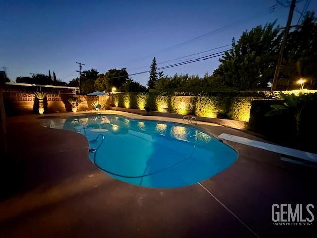 2924 Elm St, Bakersfield, CA 93301 - swimming pool with a diving board, a fenced backyard, and a patio