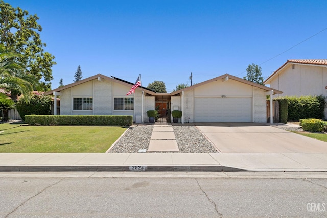 2924 Elm St, Bakersfield, CA 93301 - ranch-style house featuring brick siding, an attached garage, driveway, and a front lawn
