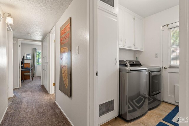 2924 Elm St, Bakersfield, CA 93301 - laundry area with independent washer and dryer, cabinet space, a textured ceiling, and light carpet