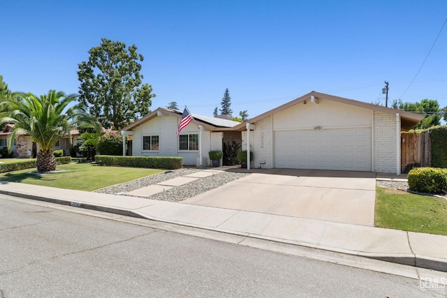 2924 Elm St, Bakersfield, CA 93301 - single story home featuring an attached garage, solar panels, brick siding, and concrete driveway