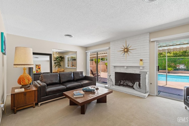 2924 Elm St, Bakersfield, CA 93301 - carpeted living room featuring a textured ceiling and a brick fireplace