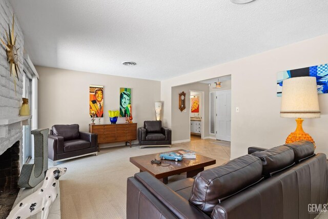 2924 Elm St, Bakersfield, CA 93301 - living area featuring a stone fireplace and a textured ceiling