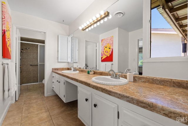 2924 Elm St, Bakersfield, CA 93301 - bathroom with double vanity, a shower stall, and tile patterned floors