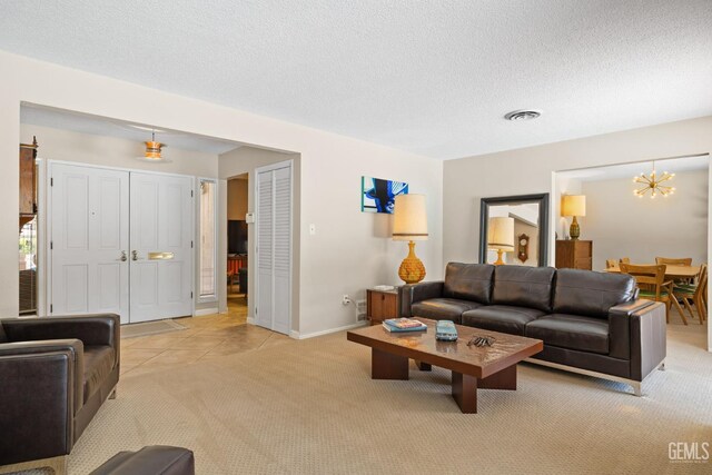 2924 Elm St, Bakersfield, CA 93301 - living area with light colored carpet, a chandelier, a textured ceiling, and light tile patterned flooring