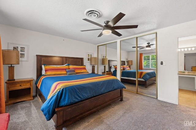 2924 Elm St, Bakersfield, CA 93301 - carpeted bedroom featuring multiple closets, a textured ceiling, and ceiling fan