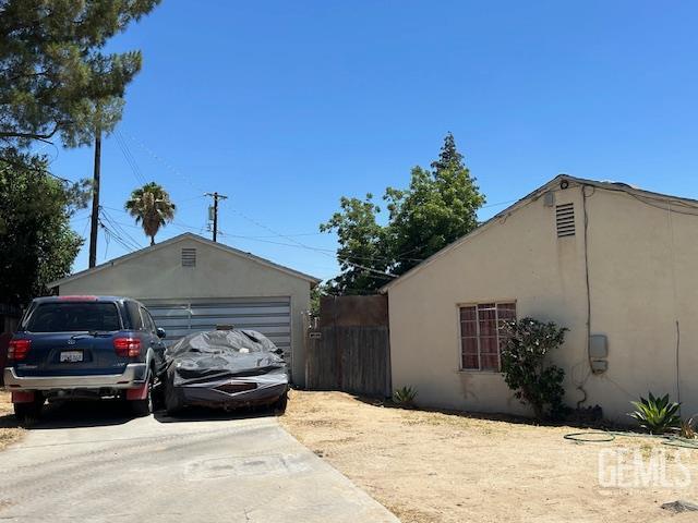 1661 Camino Sierra, Bakersfield, CA 93306 - view of property exterior featuring driveway, a garage, and stucco siding