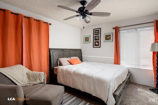 carpeted bedroom featuring a textured ceiling and ceiling fan