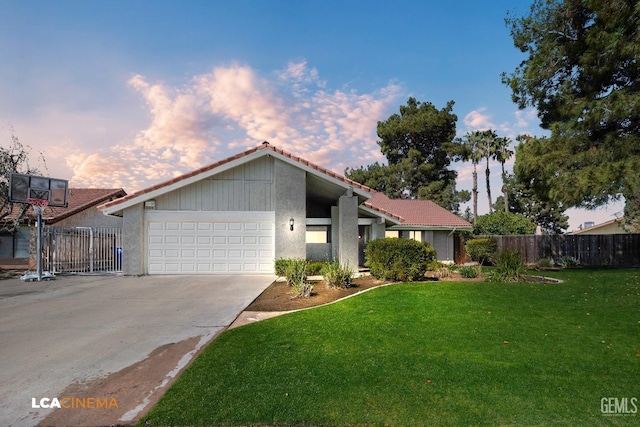 mid-century home with a front lawn, concrete driveway, fence, and a garage