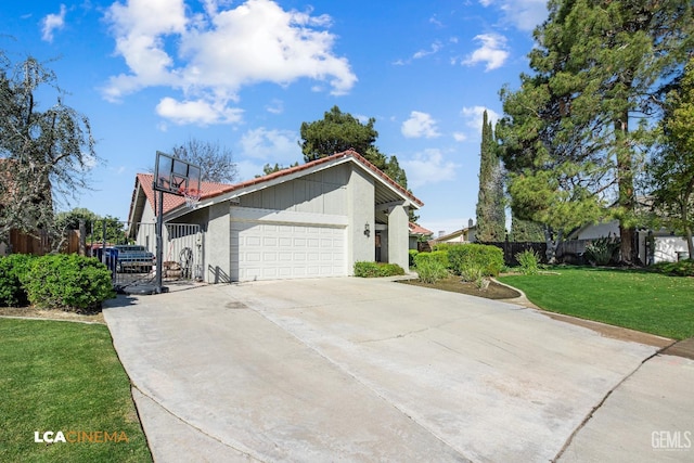 view of side of property featuring a yard, driveway, an attached garage, and fence