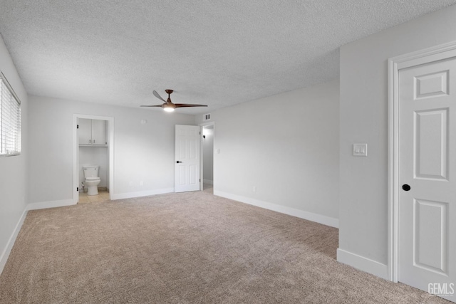 interior space with light carpet, a textured ceiling, visible vents, and baseboards