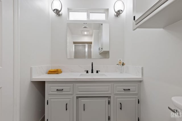 bathroom with a stall shower and vanity