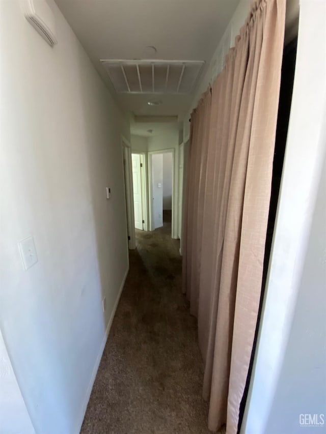 hallway featuring visible vents and carpet floors