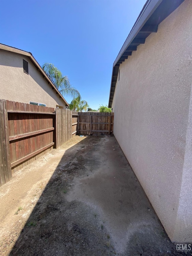 view of property exterior featuring fence and stucco siding