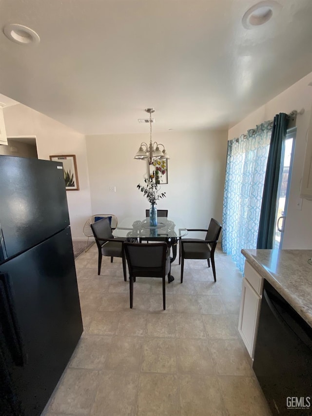 dining space featuring a notable chandelier