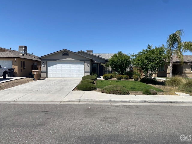 ranch-style home featuring stucco siding, central air condition unit, a front yard, concrete driveway, and an attached garage