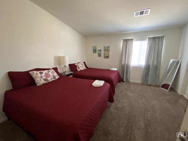 bedroom with visible vents, carpet flooring, and baseboards