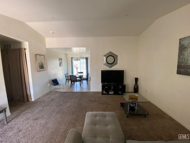 carpeted living room with lofted ceiling, a chandelier, and baseboards