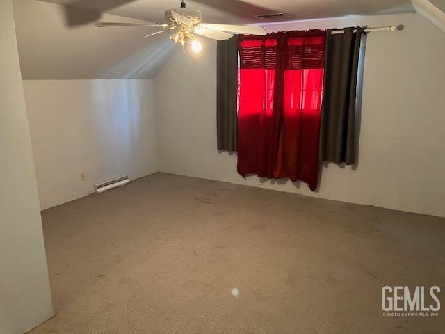 additional living space with carpet flooring, baseboard heating, ceiling fan, and lofted ceiling