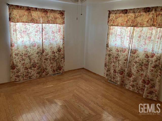 unfurnished bedroom featuring parquet floors