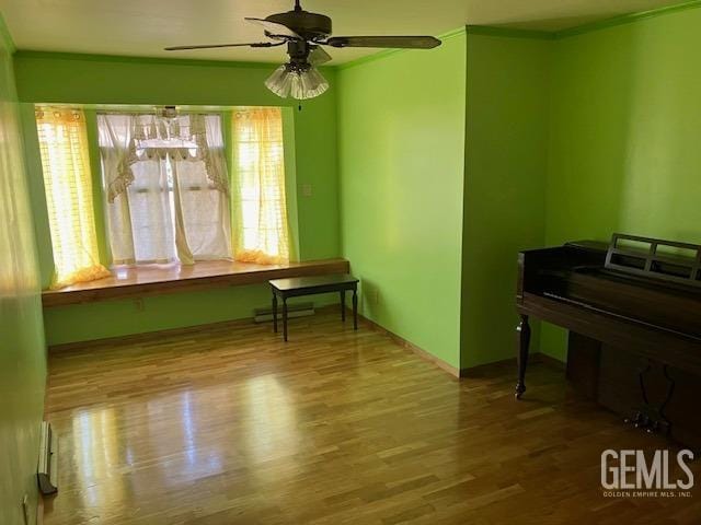 misc room featuring hardwood / wood-style flooring and ceiling fan