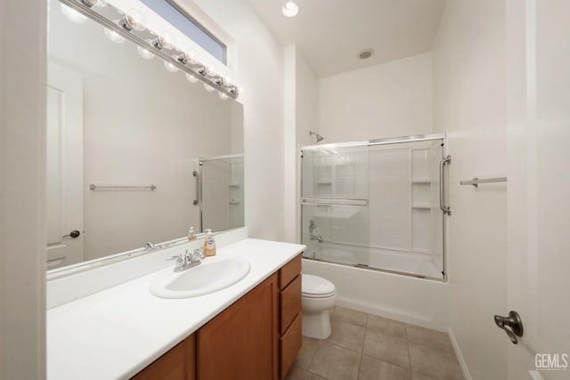 full bathroom featuring vanity, tile patterned floors, shower / bath combination with glass door, and toilet