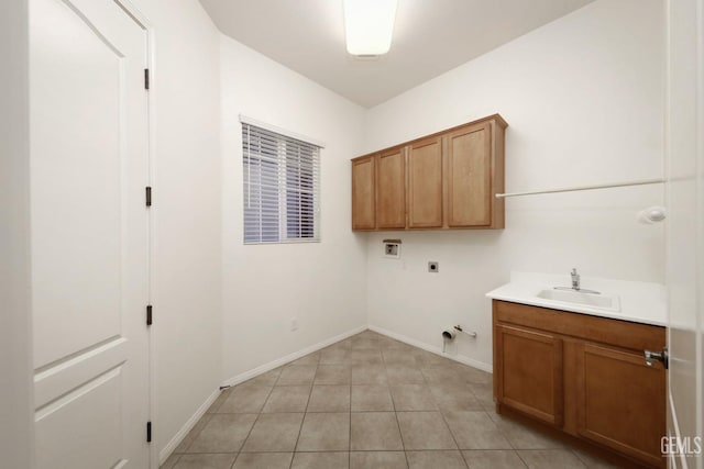 laundry area with sink, gas dryer hookup, light tile patterned floors, hookup for a washing machine, and electric dryer hookup