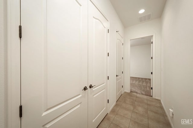 hall with light tile patterned floors