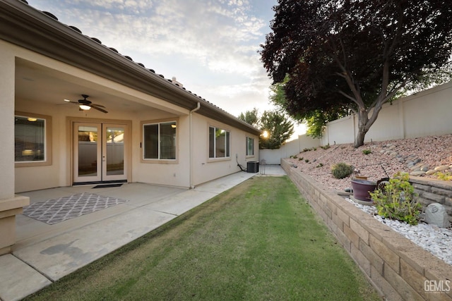 view of yard with a patio area, french doors, ceiling fan, and central air condition unit