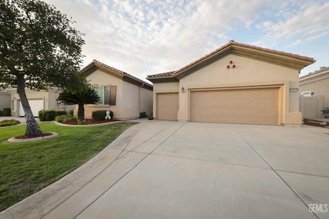 view of front facade featuring a garage and a front lawn