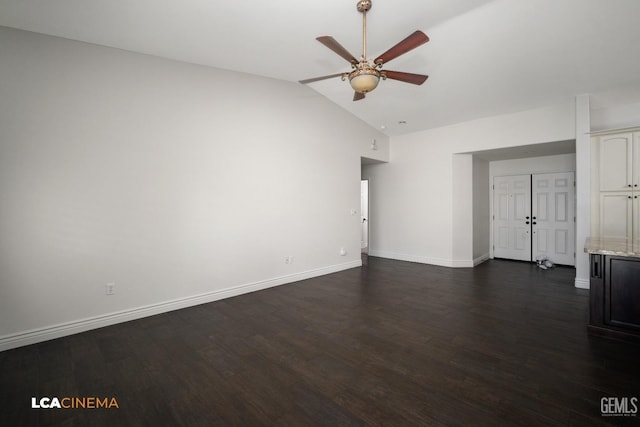 spare room with ceiling fan, lofted ceiling, and dark hardwood / wood-style flooring