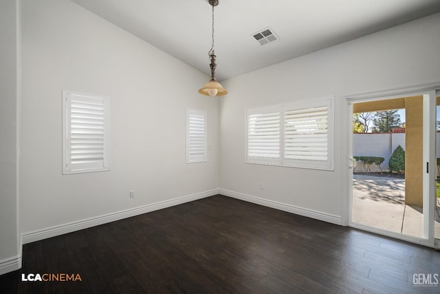 empty room with lofted ceiling and dark hardwood / wood-style floors