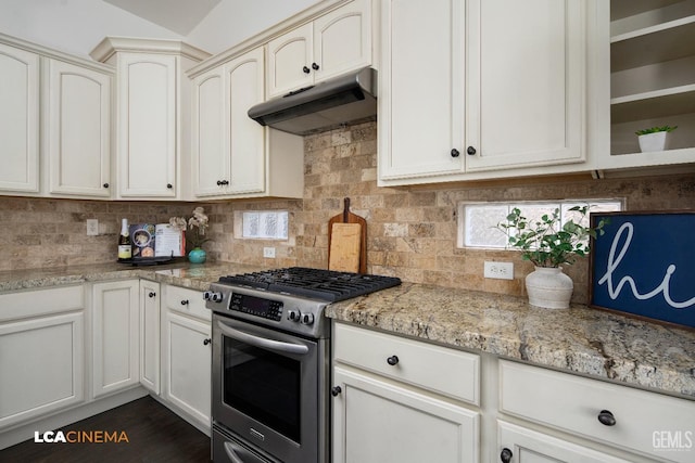 kitchen with tasteful backsplash, dark hardwood / wood-style floors, stainless steel gas range, and light stone countertops