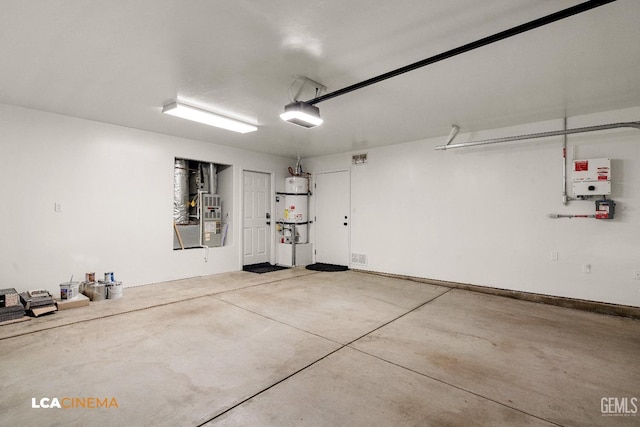 garage with heating unit, a garage door opener, strapped water heater, and water heater