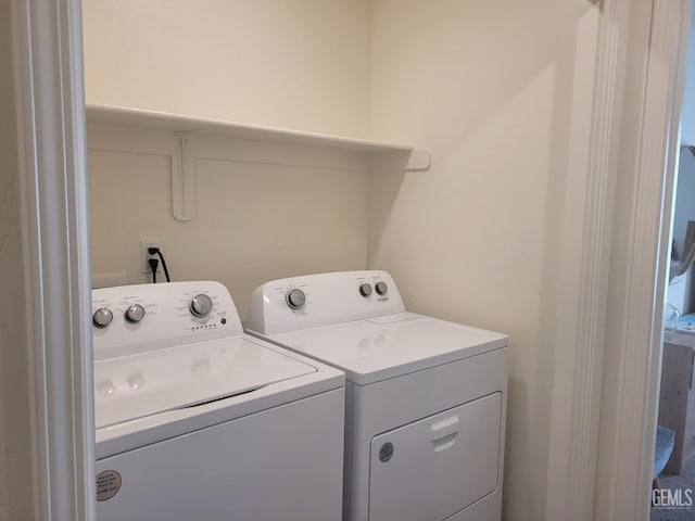 clothes washing area featuring washing machine and clothes dryer