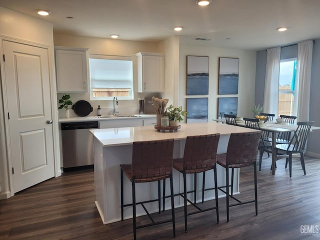 kitchen with sink, a center island, stainless steel dishwasher, and white cabinets