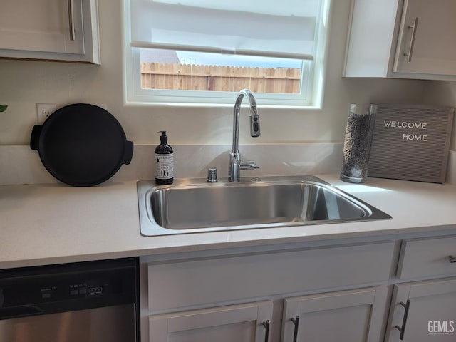 kitchen featuring white cabinetry, dishwasher, and sink