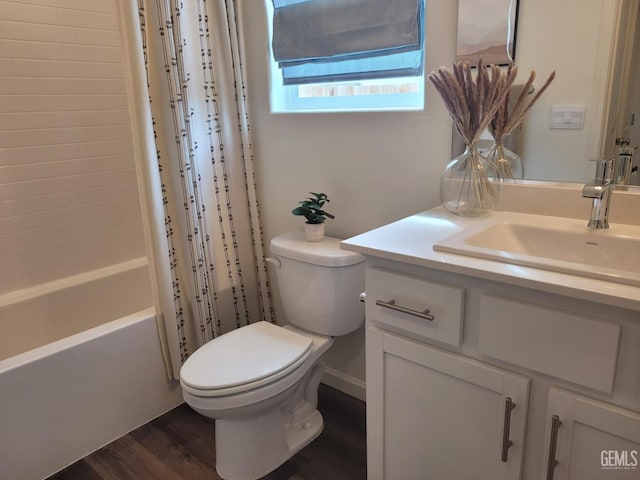 full bathroom featuring vanity, hardwood / wood-style floors, shower / bath combo with shower curtain, and toilet