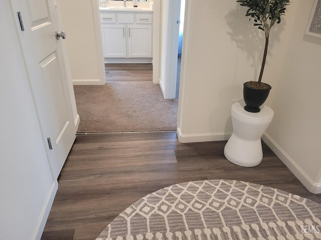 hall with dark wood-type flooring