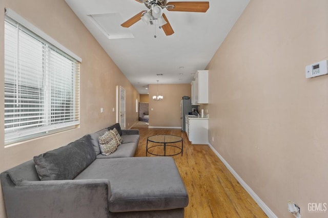 11011 Southwales Ct, Bakersfield, CA 93312 - living room featuring baseboards, light wood-style flooring, and ceiling fan