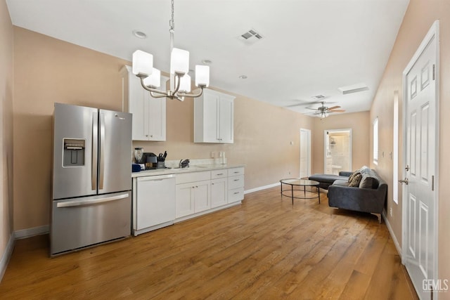 11011 Southwales Ct, Bakersfield, CA 93312 - kitchen featuring light countertops, visible vents, white cabinets, dishwasher, and stainless steel fridge with ice dispenser