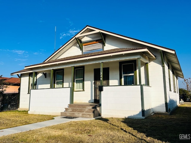 bungalow-style house with covered porch and a front yard