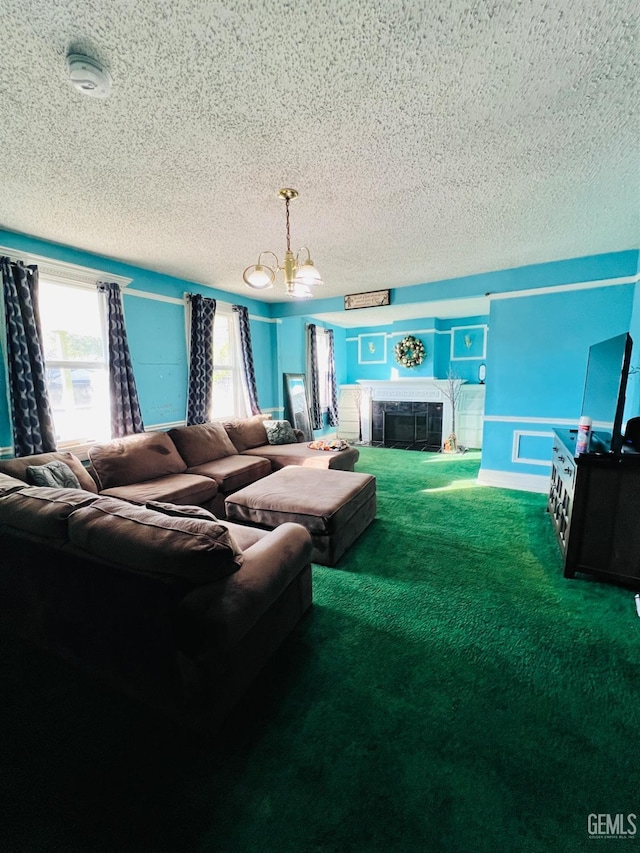 carpeted living room with a textured ceiling, an inviting chandelier, and a tiled fireplace