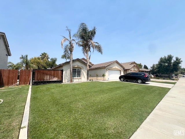 ranch-style house featuring a garage, a front yard, and fence