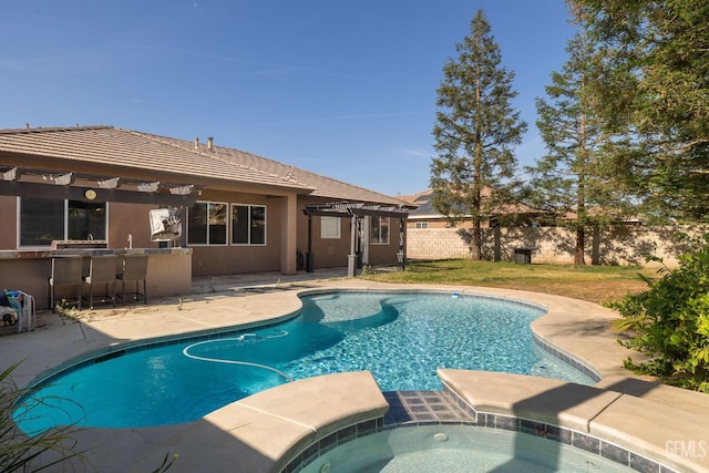 view of swimming pool with a pergola, fence, outdoor dry bar, a pool with connected hot tub, and a patio