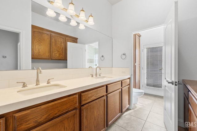 full bathroom featuring tile patterned flooring, a sink, double vanity, and toilet