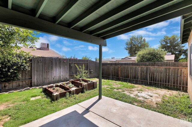5403 Cascade Ridge St, Bakersfield, CA 93307 - fenced backyard featuring a vegetable garden and a patio