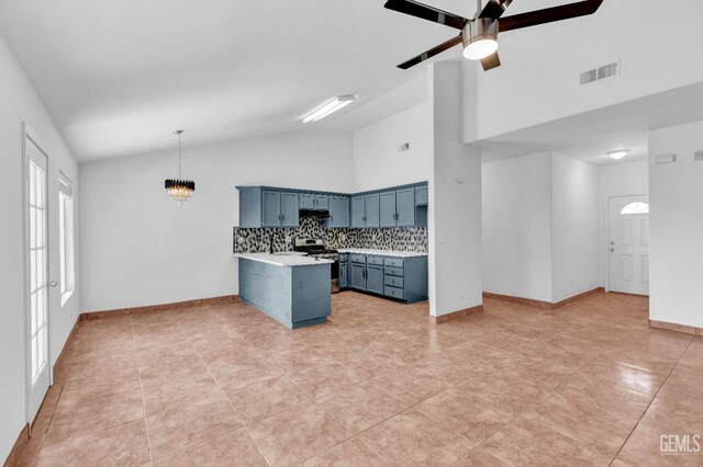 5403 Cascade Ridge St, Bakersfield, CA 93307 - kitchen featuring stainless steel range with gas stovetop, light countertops, blue cabinets, a peninsula, and tasteful backsplash