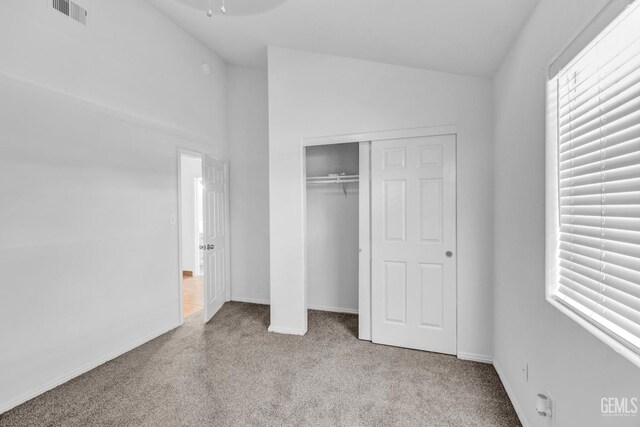 5403 Cascade Ridge St, Bakersfield, CA 93307 - unfurnished bedroom with carpet, vaulted ceiling, a closet, and multiple windows