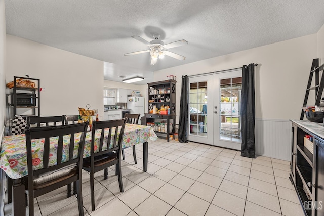3700 Wenatchee Ave, Bakersfield, CA 93306 - dining room with french doors, a wainscoted wall, a textured ceiling, ceiling fan, and light tile patterned flooring